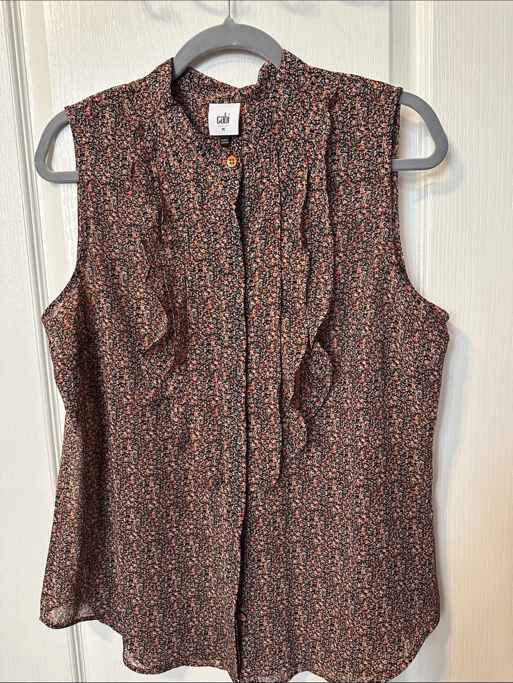 CAbi Sleeveless Ruffle Front Blouse in Black and Rust Floral
